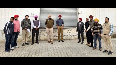 Officials during inspection at a warehouse of a company in Ludhiana on Sunday. (HT photo)