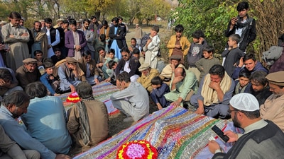 People mourn over the graves of relatives who were killed after gunmen opened fire on passenger vehicles in the Kurram tribal district of Khyber Pakhtunkhwa province, in Shalozan, Pakistan November 22. (Reuters) People mourn over the graves of relatives who were killed after gunmen opened fire on passenger vehicles in the Kurram tribal district of Khyber Pakhtunkhwa province, in Shalozan, Pakistan November 22. (Reuters)