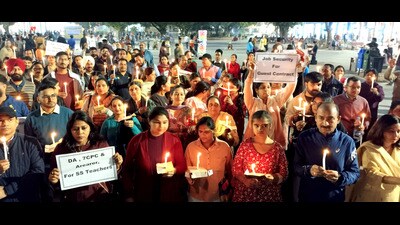 Teachers during a candle march protest at the Sector 17 Plaza in Chandigarh on Sunday. (HT Photo)