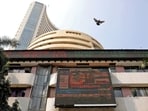 A bird flies past a screen displaying the Sensex results on the facade of the Bombay Stock Exchange (BSE) building in Mumbai.