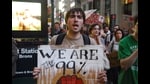 A man holding a sign that says, “We Are The 99%” at an Occupy Wall Street protest. Rumaan Alam’s ‘Entitlement’ is set in the wake of the Occupy Wall Street Movement. (Wikimedia Commons)