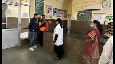 Civil hospital staff trying to demonstrate use of fire extinguisher during an inspection in Ludhiana on Monday. (HT Photo)