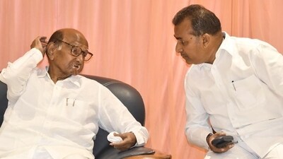 NCP President Sharad Pawar with party leader Balasaheb Patil during a party workers meeting, in Karad, Maharashtra, Sunday. (PTI) NCP President Sharad Pawar with party leader Balasaheb Patil during a party workers meeting, in Karad, Maharashtra, Sunday. (PTI)