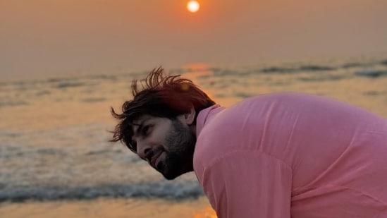 Kartik Aaryan, in a candid photo, was seen bending and looking away from the camera.