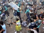 Policemen charge baton to disperse the supporters of Bangladeshi Hindu leader Krishna Das Prabhu after they surrounded police van carrying their leader.