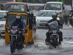 Commuters move through flooded roads as heavy rains lash Chennai and other Tamil Nadu regions. Commuters move through flooded roads as heavy rains lash Chennai and other Tamil Nadu regions.