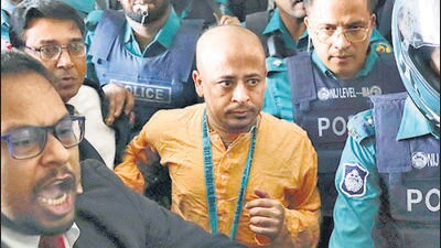 Chinmoy Krishna Das, a Hindu leader associated with the International Society for Krishna Consciousness (ISKCON), who faces several charges, is escorted by the police at the Chattogram Metropolitan Magistrate Court, in Chattogram, Bangladesh. (REUTERS) Chinmoy Krishna Das, a Hindu leader associated with the International Society for Krishna Consciousness (ISKCON), who faces several charges, is escorted by the police at the Chattogram Metropolitan Magistrate Court, in Chattogram, Bangladesh. (REUTERS)