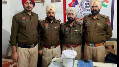 GRP officials with the seized weapons at the Dhandhari railway station on Tuesday. (HT photo)