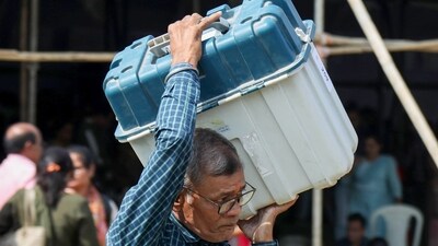 File Photo: A poll official with an electronic voting machine (EVM) File Photo: A poll official with an electronic voting machine (EVM)