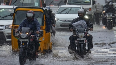 Commuters move through flooded roads as heavy rains lash Chennai and other Tamil Nadu regions. (PTI) Commuters move through flooded roads as heavy rains lash Chennai and other Tamil Nadu regions. (PTI)