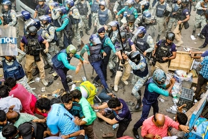 Police personnel baton-charge protesting supporters of Chinmoy Krishna Das in Chittagong. (AFP) Police personnel baton-charge protesting supporters of Chinmoy Krishna Das in Chittagong. (AFP)