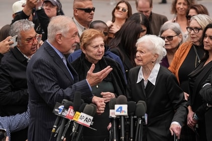 Holding the hand of Teresita Baralt, the sister of Jose Menendez, attorney Mark Geragos, left, talks to Joan Andersen VanderMolen, center right, Erik and Lyle Menendez's aunt, during a news conference after a hearing in Los Angeles, Monday, Nov. 25, 2024. (AP / Jae C. Hong) Holding the hand of Teresita Baralt, the sister of Jose Menendez, attorney Mark Geragos, left, talks to Joan Andersen VanderMolen, center right, Erik and Lyle Menendez's aunt, during a news conference after a hearing in Los Angeles, Monday, Nov. 25, 2024. (AP / Jae C. Hong)