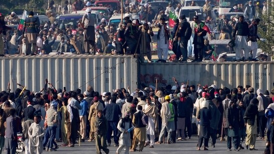 Pakistan Tehree-e-Insaaf (PTI)'s supporters broke through several security barriers on the roads and removed shipping containers placed to block their way.&nbsp;(AP)