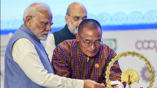 Prime Minister Narendra Modi with Bhutan Prime Minister Tshering Tobgay light the lamp at the inauguration of International Cooperative Alliance Global Cooperative Conference 2024 in New Delhi on Monday. (DPR PMO/ANI)