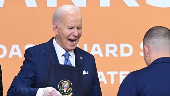 Joe Biden declares ‘I’ve been fired’ while sneaking bites from ‘friendsgiving’ military buffet (Photo by SAUL LOEB / AFP) (AFP)