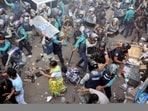 Policemen charge baton to disperse the supporters of Bangladeshi Hindu leader Krishna Das Prabhu