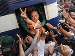 Bangladeshi Hindu leader Krishna Das Prabhu shows a victory sign as he is taken in a police van after the court ordered him detained pending further proceedings in Chattogram on November 26,