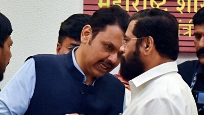 Eknath Shinde in a conversation with CM Devendra Fadnavis during a press conference in Mumbai. (ANI Photo)