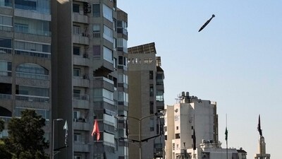 A bomb dropped from an Israeli jet prepares to hit a building in Tayouneh, Beirut, Lebanon. (AP) A bomb dropped from an Israeli jet prepares to hit a building in Tayouneh, Beirut, Lebanon. (AP)