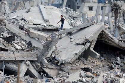 A Palestinian boy stands on the rubble of a house destroyed in Israel's military offensive, amid the ongoing conflict between Israel and Hamas, in Khan Younis in the southern Gaza Strip October 7, 2024. (REUTERS)
