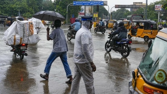 A traffic police personnel manages traffic during rain in Chennai. (File) (PTI)