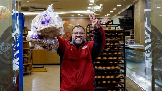 A man reacts as he buys bread on his way back to southern Lebanon, after a ceasefire between Israel and Iran-backed group Hezbollah took effect.(REUTERS)