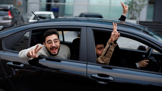 People celebrate as they arrive back in Tyre, after a ceasefire between Israel and Iran-backed group Hezbollah took effect.(REUTERS)