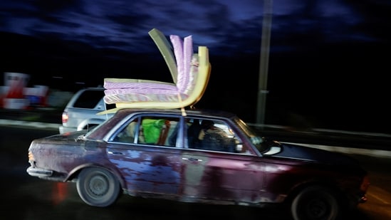 A vehicle transporting mattresses drives towards southern Lebanon on a highway.(REUTERS)