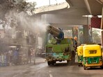PMC workers using anti smog gun for reducing Air Pollution at R'Block in Patna, Bihar.