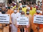 ISKON priests hold placards during a protest against violence in Bangladesh.
