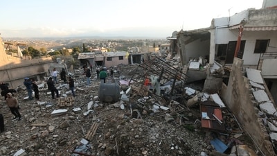 People gather at a damaged site in Tayr Debba, on the second day of the ceasefire between Israel and Iran-backed group Hezbollah. (REUTERS)