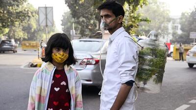 People wear masks during a protest against the rise in air pollution in New Delhi on Wednesday. (ANI Photo) People wear masks during a protest against the rise in air pollution in New Delhi on Wednesday. (ANI Photo)