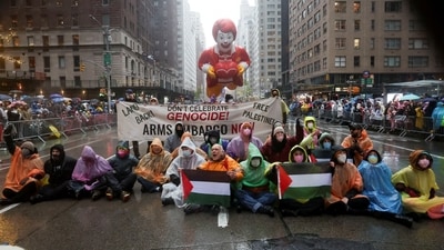 People protest during the 98th Macy's Thanksgiving Day Parade in New York City. (REUTERS)