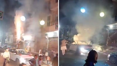 In a terrifying video, a man can be seen emerging from a car's sunroof and lighting up rockets to shoot into the air. (X/@HateDetectors) In a terrifying video, a man can be seen emerging from a car's sunroof and lighting up rockets to shoot into the air. (X/@HateDetectors)