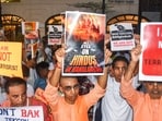 People holding placards take part in a protest rally against the arrest of ISKCON monk Chinmay Prabhu by Dhaka police.
