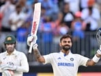 Virat Kohli celebrates reaching his century (100 runs) during day three of the first Test cricket match between Australia and India