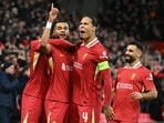 Liverpool's Dutch striker Cody Gakpo (2L) celebrates scoring the team's second goal with Liverpool's Dutch defender Virgil van Dijk during the UEFA Champions League football match vs Real Madrid