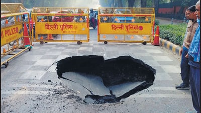 The caved-in portion of the Ashoka Road in New Delhi on Friday. (HT PHOTO)