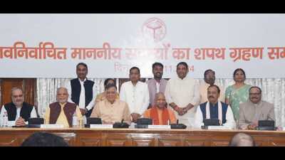 Uttar Pradesh chief minister Yogi Adityanath, Assembly speaker Satish Mahana with the newly elected BJP legislators after their oath-taking in Lucknow on Friday (HT Photo)
