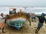 Fishermen move a boat to a safer place as a deep depression over the Bay of Bengal is expected to intensify into cyclone 'Fengal', in Tiruchirappalli, Tamil Nadu.