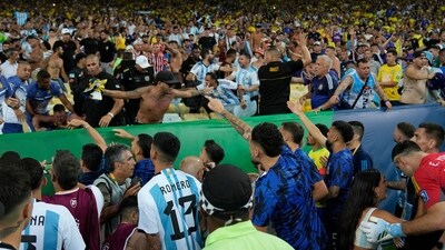 Players of Argentina try to calm the crowd after a fight between Brazilian and Argentinian fans. (AP Photo/Silvia Izquierdo) (AP)