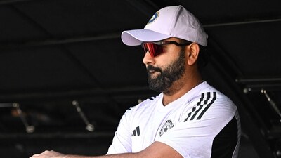 India's Rohit Sharma looks on from the pavilion. (Photo by SAEED KHAN / AFP) (AFP) India's Rohit Sharma looks on from the pavilion. (Photo by SAEED KHAN / AFP) (AFP)