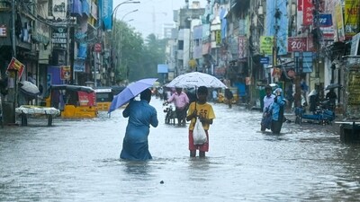 People wade through a flooded street as it rains ahead of a cyclonic storm in Chennai on November 30, 2024. (AFP) People wade through a flooded street as it rains ahead of a cyclonic storm in Chennai on November 30, 2024. (AFP)