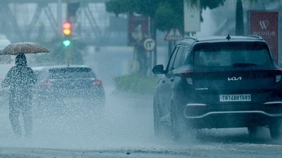 People commute along a street amid heavy rains ahead of a cyclonic storm in Chennai on November 30, 2024. (AFP)