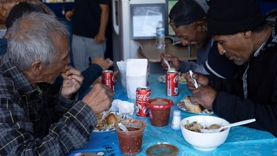 Migrants deported from the US celebrate the traditional Thanksgiving with a meal offered by deported migrant Esther Morales at her restaurant. (REUTERS)