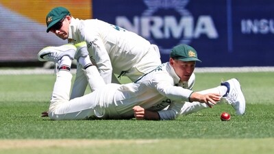 Australia's Marnus Labuschagne, right, reaches out for the ball as he and teammate Steve Smith attempt to field the ball during the Perth Test. (AP) Australia's Marnus Labuschagne, right, reaches out for the ball as he and teammate Steve Smith attempt to field the ball during the Perth Test. (AP)