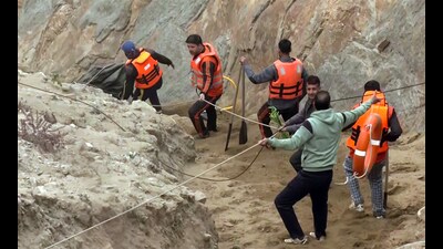 National Disaster Response Force (NDRF) and State Disaster Response Force (SDRF) personnel conduct the rescue operation after a vehicle plunged into the Chenab River, in Doda on Saturday. (ANI)