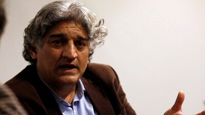 Matiullah Jan, a journalist and columnist, gestures during an interview with Reuters at his office in Islamabad, Pakistan (REUTERS)