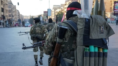 Anti-government fighters patrol in central Aleppo on November 30, 2024. (AFP) Anti-government fighters patrol in central Aleppo on November 30, 2024. (AFP)