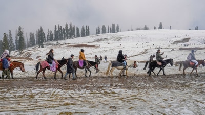 Gulmarg: Tourists take a pony ride after the season's first snowfall, at Kongdoori area of Gulmarg, in Baramulla district (PTI Photo/S Irfan) Gulmarg: Tourists take a pony ride after the season's first snowfall, at Kongdoori area of Gulmarg, in Baramulla district (PTI Photo/S Irfan)